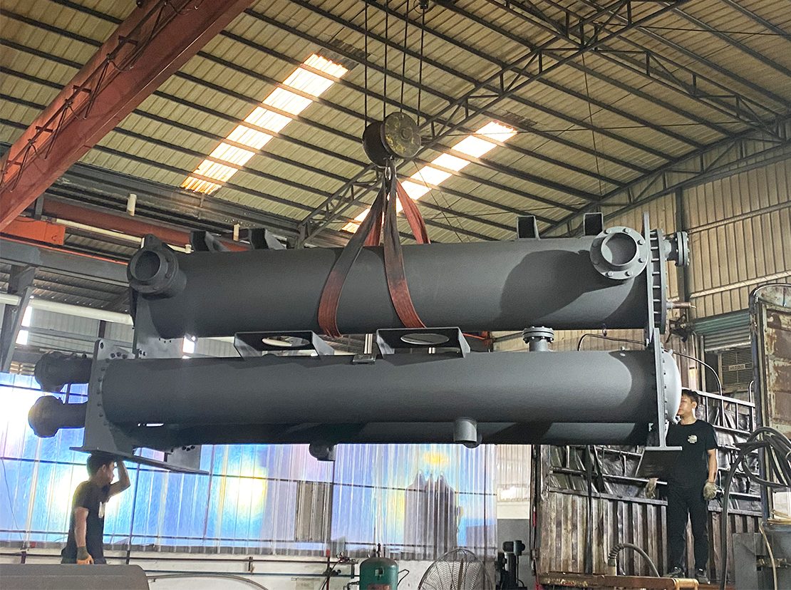 Overhead crane lifting a completed shell