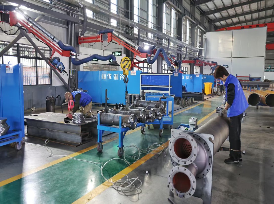 Two flanged exchangers being assembled, tube sheets facing the camera