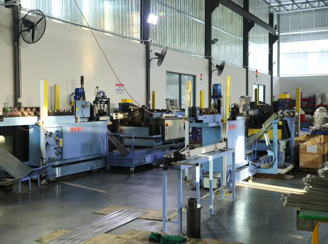 Tube-processing line forming and cutting heat-exchanger tubes